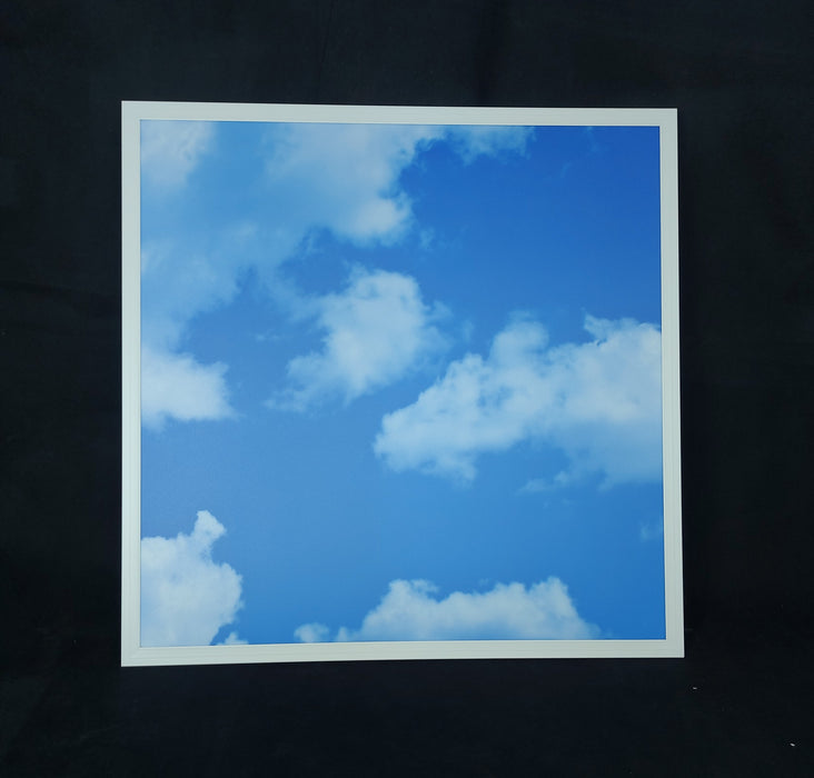 Framed photograph of a blue sky with white clouds on a black background